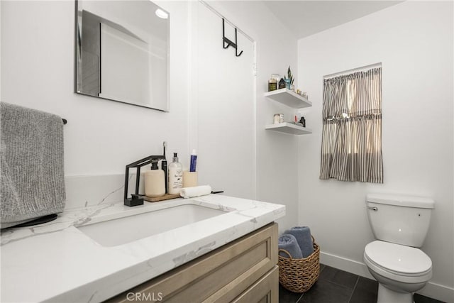 bathroom featuring vanity, tile patterned floors, and toilet