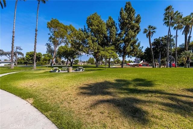 view of property's community with a lawn