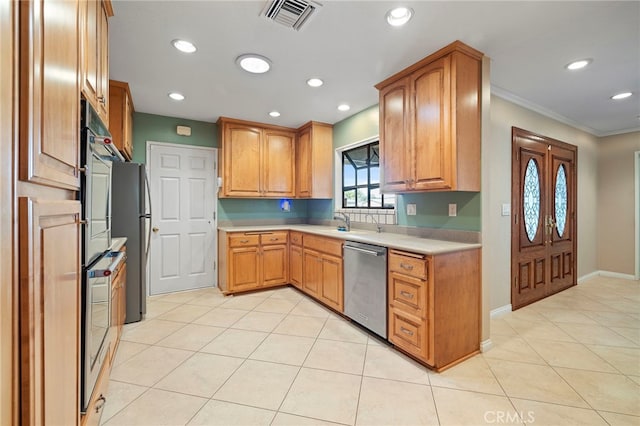 kitchen featuring light tile patterned flooring, appliances with stainless steel finishes, and ornamental molding