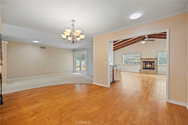 unfurnished room featuring lofted ceiling with beams, ornamental molding, light hardwood / wood-style floors, ceiling fan with notable chandelier, and beverage cooler