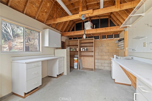 unfurnished office with vaulted ceiling