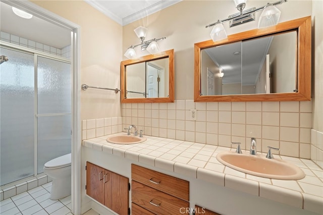 bathroom featuring a shower with shower door, tasteful backsplash, ornamental molding, vanity, and toilet