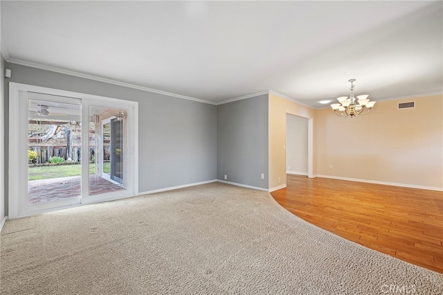 empty room featuring an inviting chandelier, carpet flooring, and crown molding