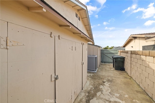 view of side of home with central AC