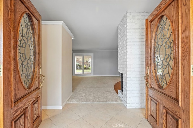 carpeted foyer featuring a fireplace and ornamental molding