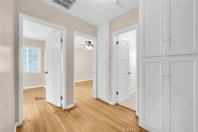 hallway with light hardwood / wood-style floors