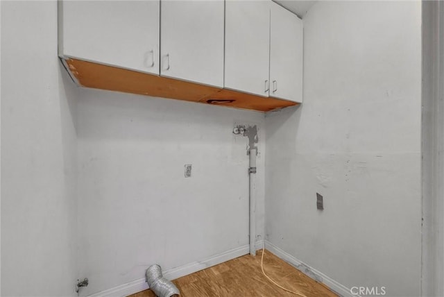 washroom featuring hardwood / wood-style flooring and cabinets