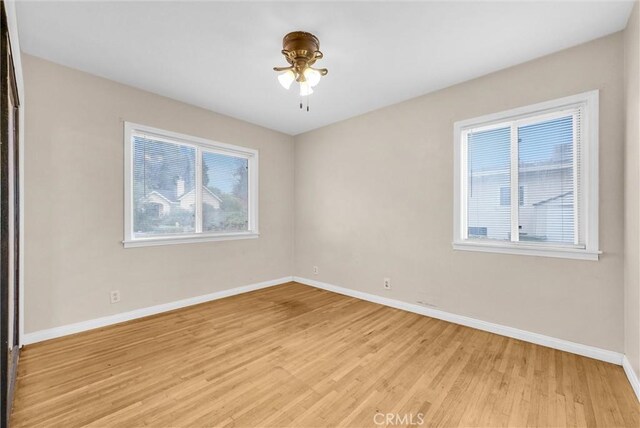 unfurnished room with ceiling fan and light hardwood / wood-style flooring