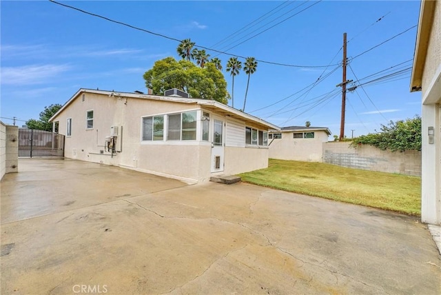 back of house featuring a yard and a patio