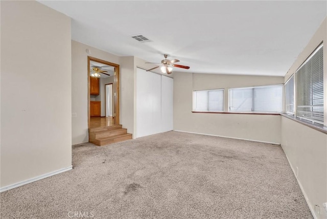 carpeted spare room with lofted ceiling