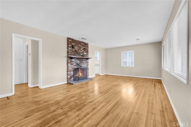 unfurnished living room featuring light hardwood / wood-style flooring and a fireplace