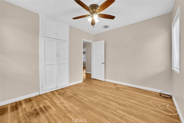 unfurnished bedroom with light hardwood / wood-style flooring, a closet, and ceiling fan