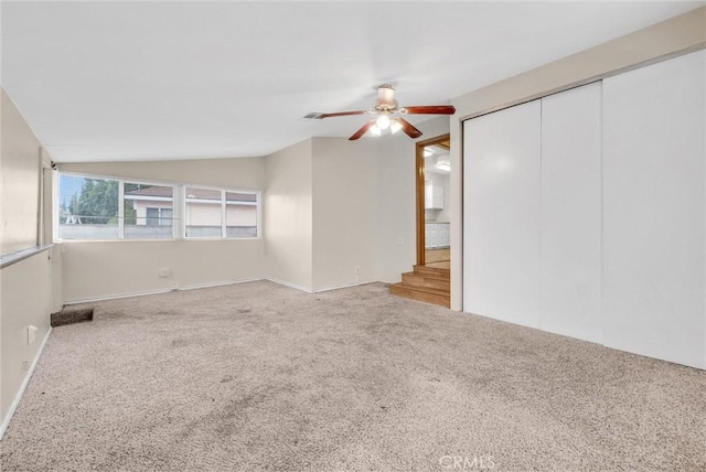 unfurnished room with ceiling fan, lofted ceiling, and carpet floors