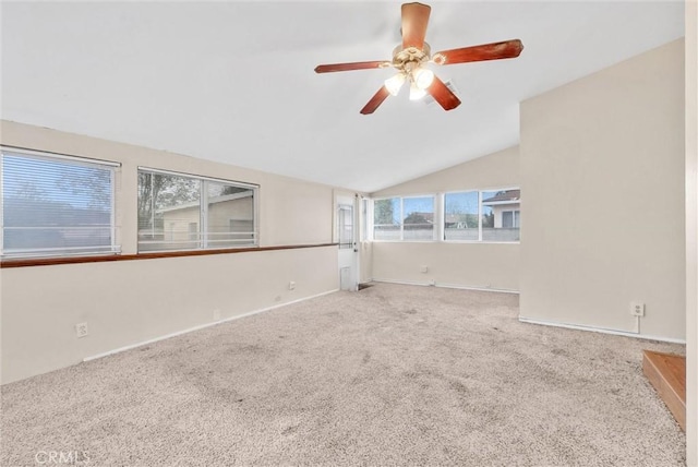 carpeted empty room with ceiling fan and vaulted ceiling