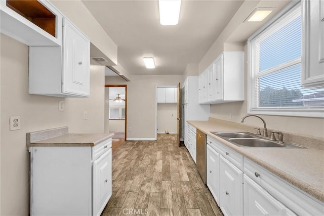 kitchen with white cabinetry, ceiling fan, sink, and light hardwood / wood-style flooring