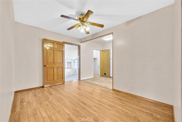 empty room featuring ceiling fan and light hardwood / wood-style flooring