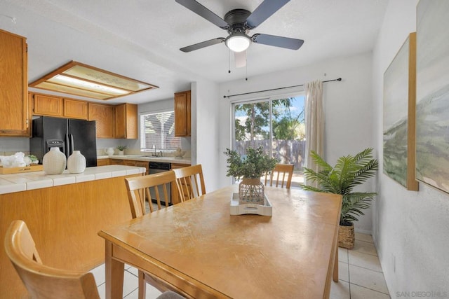 dining area with light tile patterned floors and sink