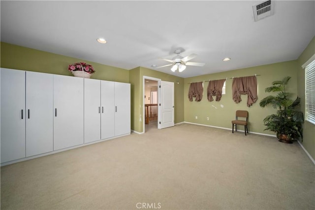 unfurnished bedroom featuring ceiling fan and light carpet