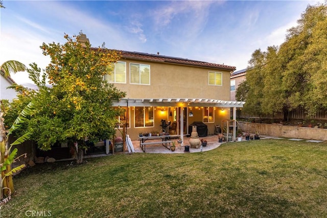 rear view of house featuring a pergola, a yard, and a patio area