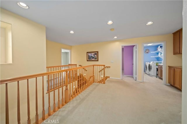 hall featuring light colored carpet and washing machine and dryer