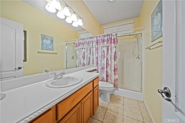 bathroom featuring vanity, toilet, tile patterned floors, and walk in shower