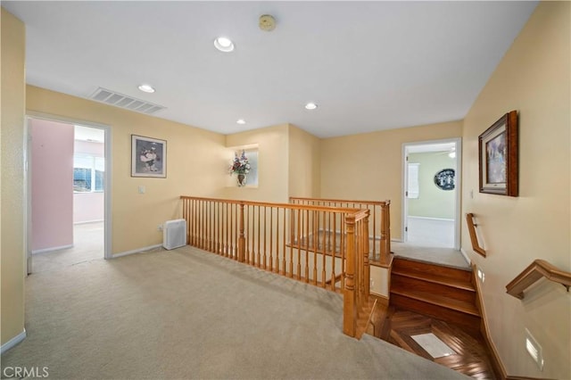 hallway featuring light colored carpet