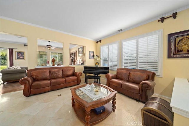 living room featuring ornamental molding and light tile patterned floors