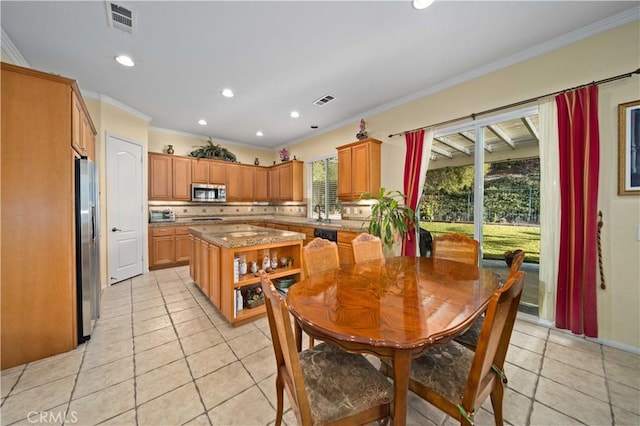 tiled dining area featuring crown molding