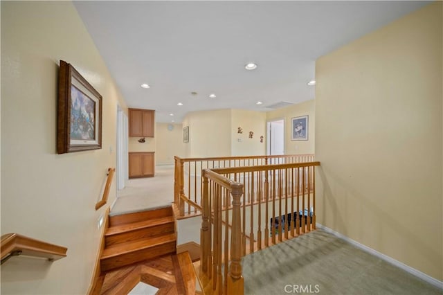 staircase featuring carpet flooring