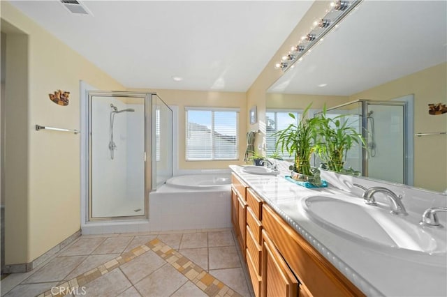 bathroom featuring tile patterned flooring, vanity, and plus walk in shower