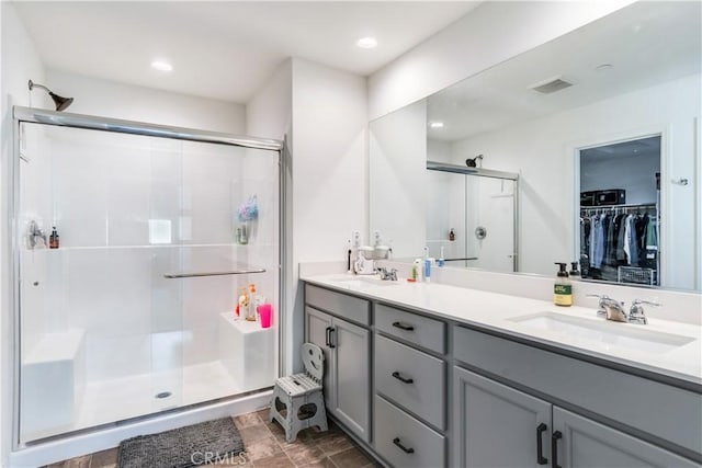 bathroom featuring vanity and a shower with shower door