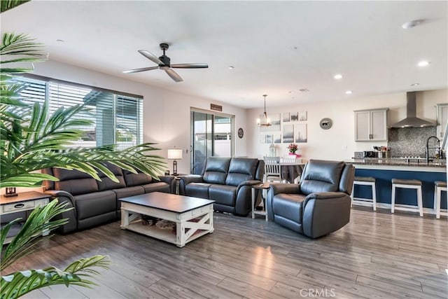 living room with ceiling fan and dark hardwood / wood-style flooring