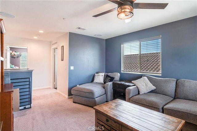 living room with light colored carpet and ceiling fan