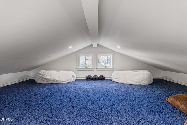 unfurnished bedroom featuring vaulted ceiling and carpet flooring