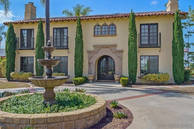 mediterranean / spanish home featuring french doors