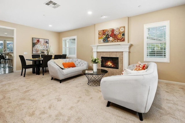 carpeted living room with a healthy amount of sunlight and a fireplace