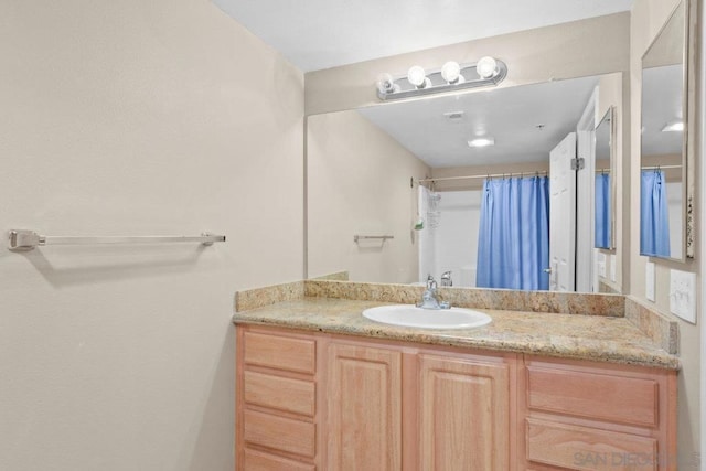 bathroom with vanity and a shower with shower curtain