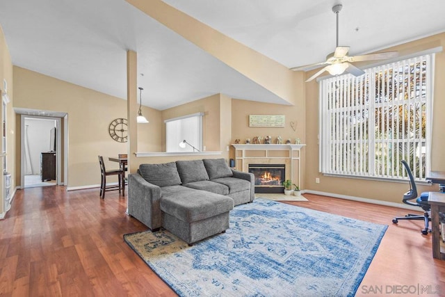 living room featuring lofted ceiling, hardwood / wood-style flooring, and ceiling fan