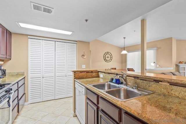 kitchen featuring lofted ceiling, sink, light tile patterned floors, pendant lighting, and white appliances