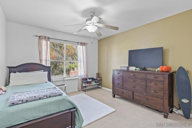 bedroom with ceiling fan and light carpet