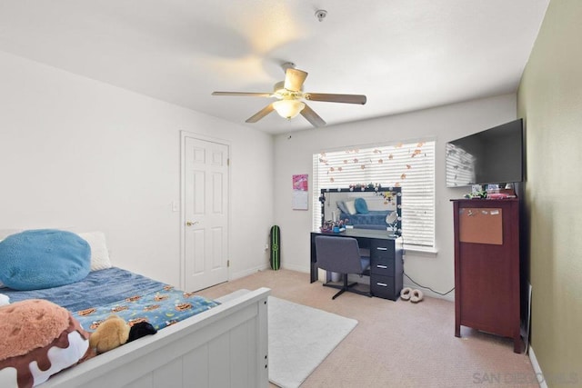 bedroom featuring light carpet and ceiling fan