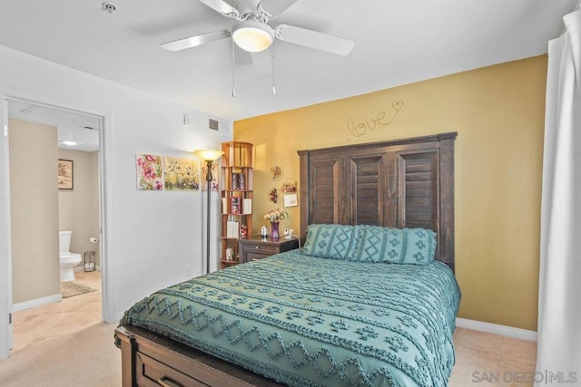 carpeted bedroom with connected bathroom and ceiling fan