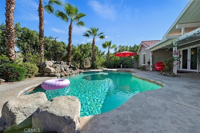 view of swimming pool with a patio