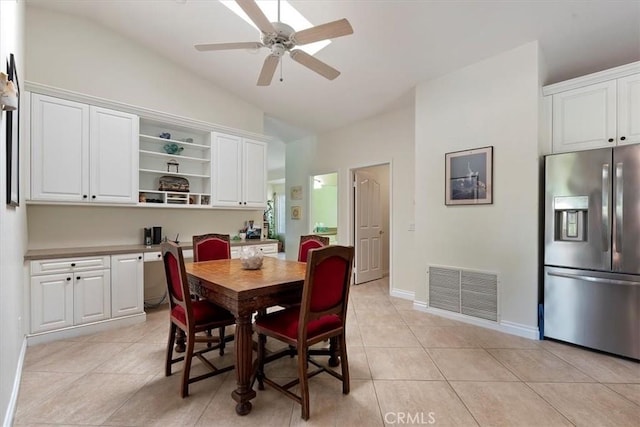 dining area featuring vaulted ceiling, light tile patterned flooring, and ceiling fan