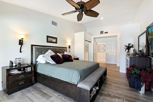 bedroom featuring ceiling fan, lofted ceiling, and wood-type flooring