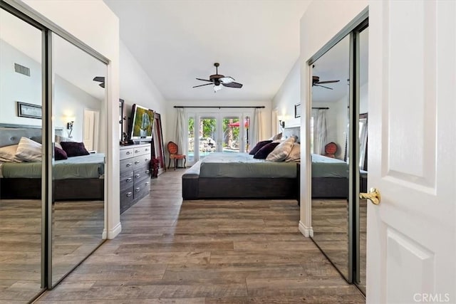 bedroom featuring ceiling fan, dark hardwood / wood-style floors, vaulted ceiling, and access to exterior