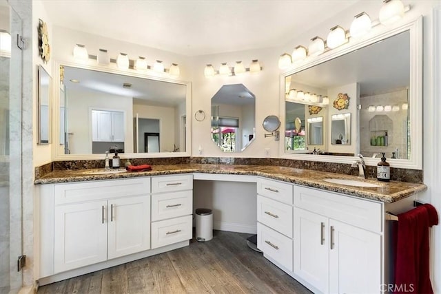 bathroom with vanity, an enclosed shower, and wood-type flooring