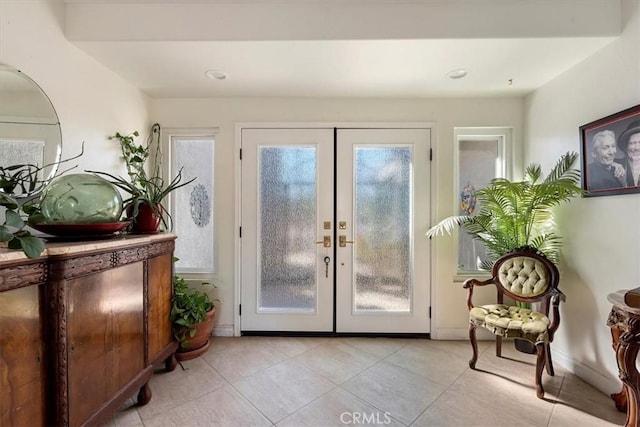 entryway featuring french doors and light tile patterned flooring