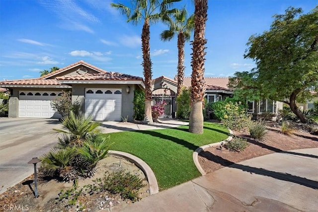 mediterranean / spanish-style house featuring a garage and a front yard