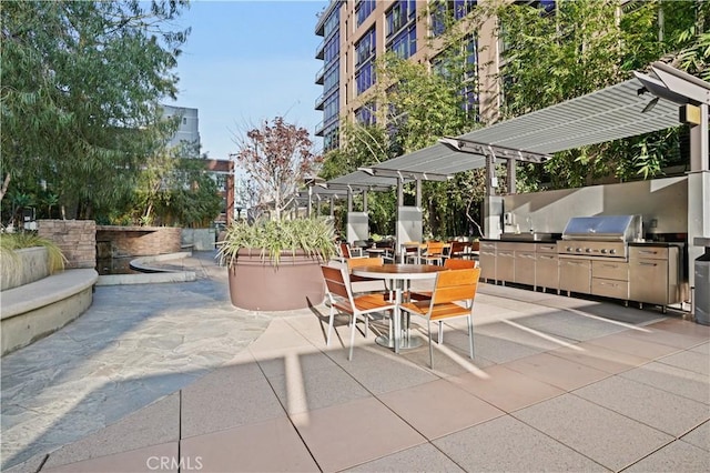 view of patio featuring area for grilling, a grill, and a pergola